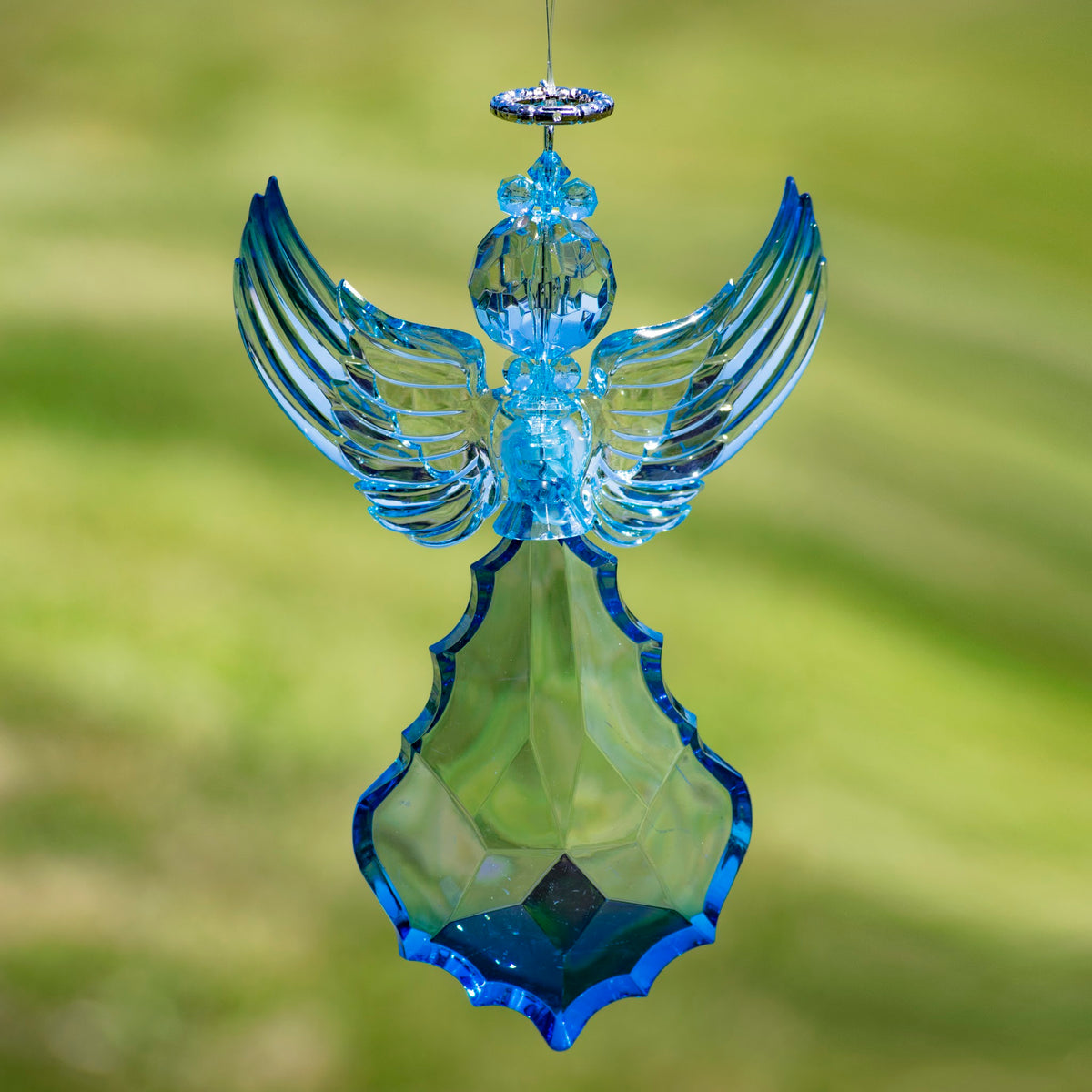 Blue angel ornament hanging with its wings raised in a tall V shape.