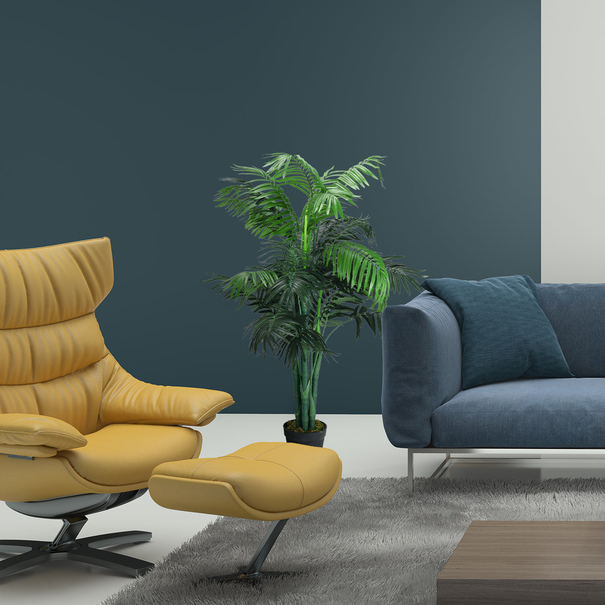 A leafy artificial palm in a small black pot stands between a mustard recliner and a blue sofa.
