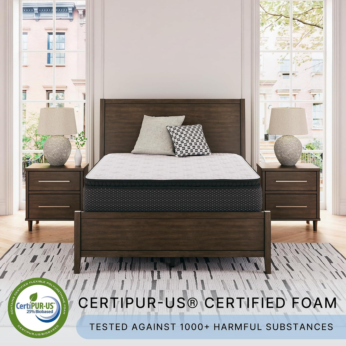Full front view of the mattress on a dark wood bed in a bright bedroom with matching nightstands