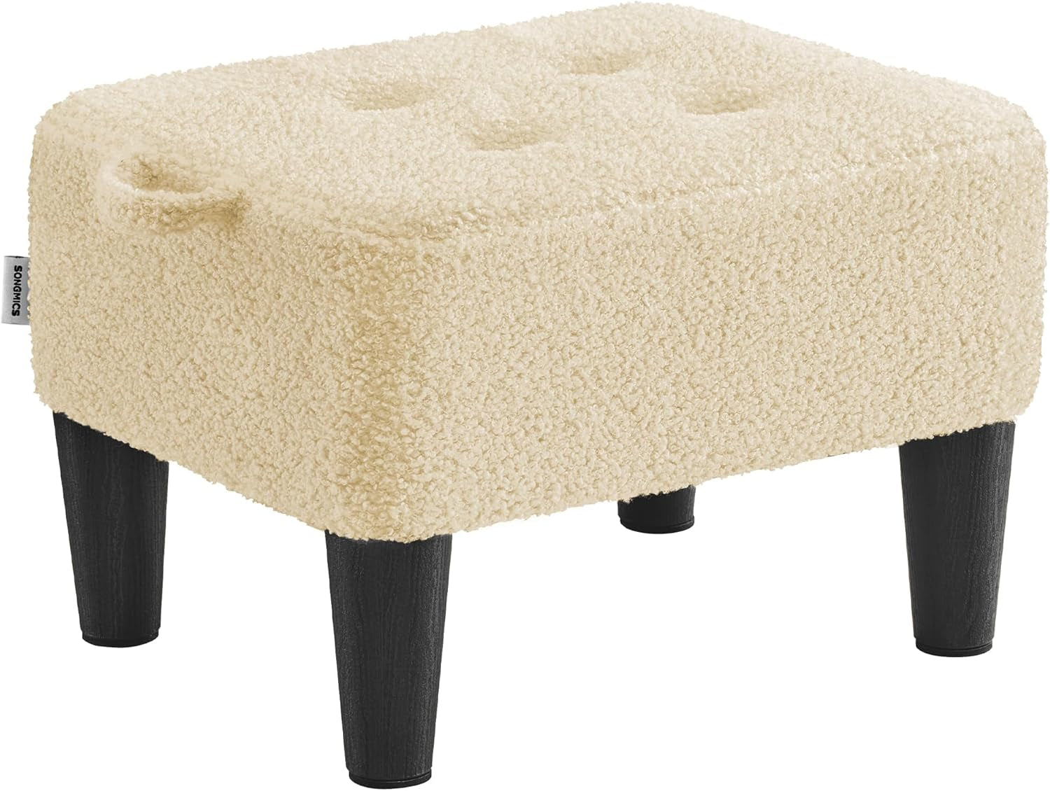Cream-colored sherpa-covered square ottoman with tufted top and black tapered legs, angled left.