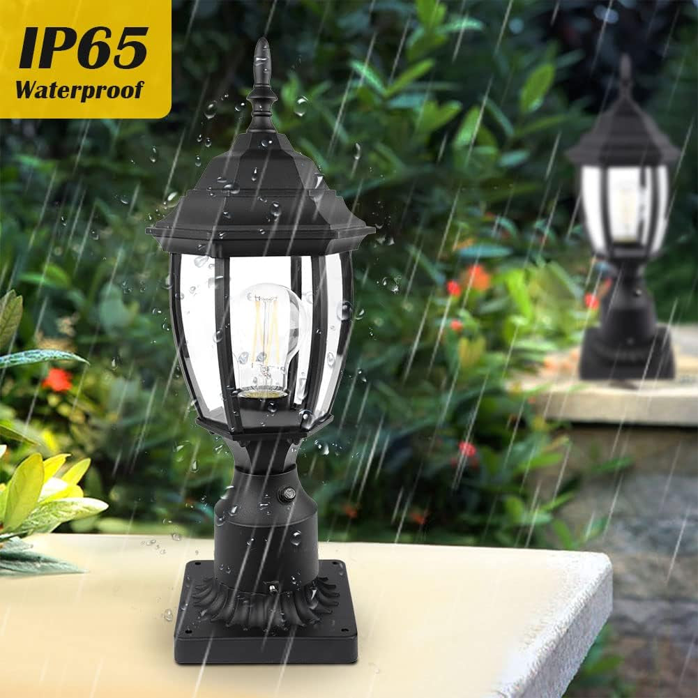 Black outdoor post lantern installed on a square pier base in a rainy garden setting, angled front view