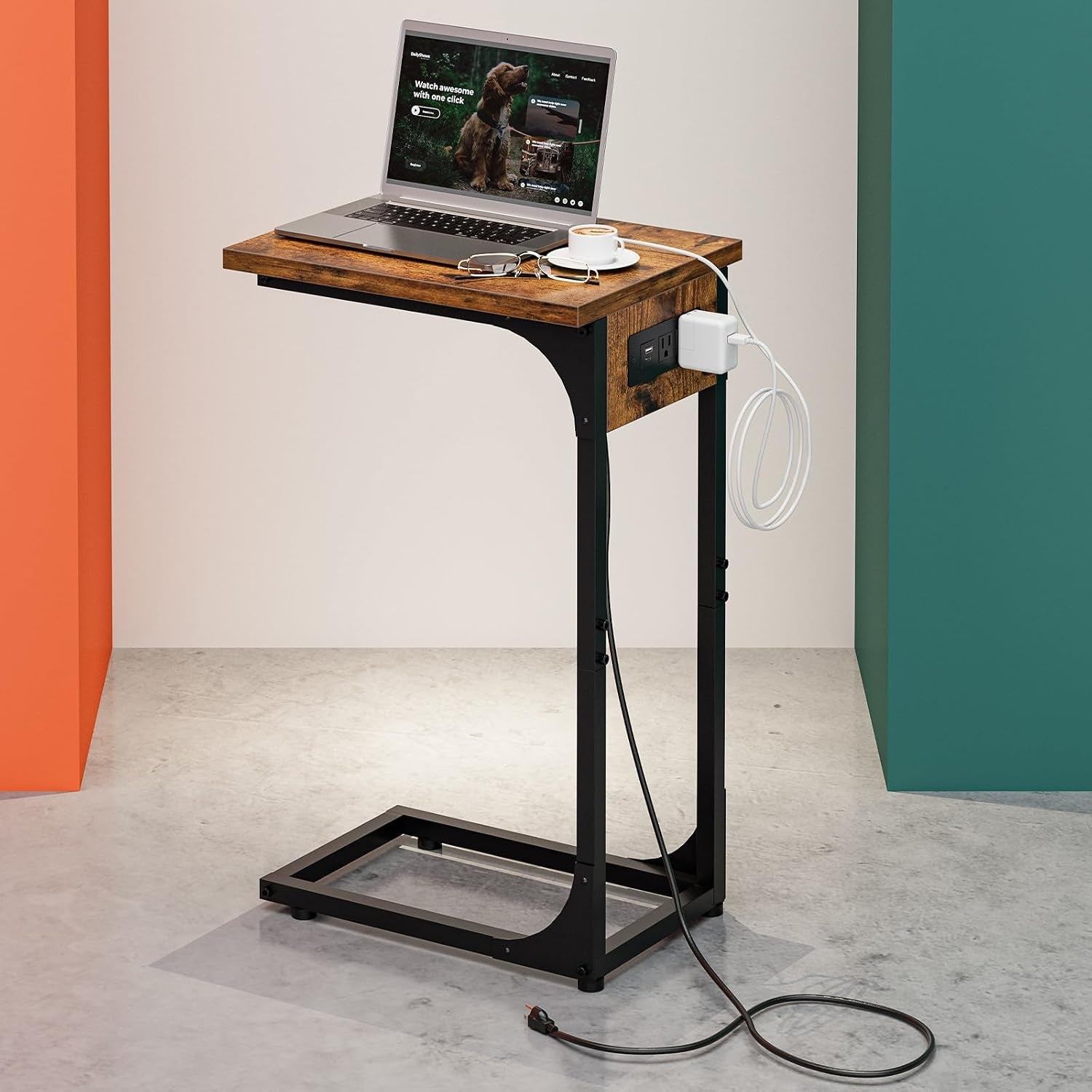 C-shaped side table with distressed wood top and black metal frame, laptop and charger on the side outlet.