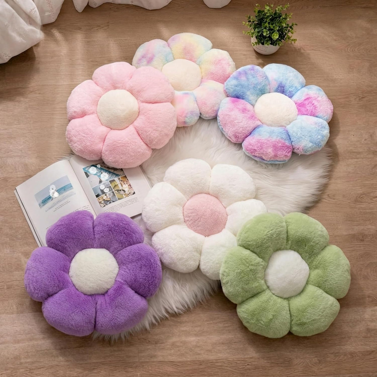 Assorted daisy plush pillows in pink, purple, green and multicolor arranged on a wooden floor over a white fur rug