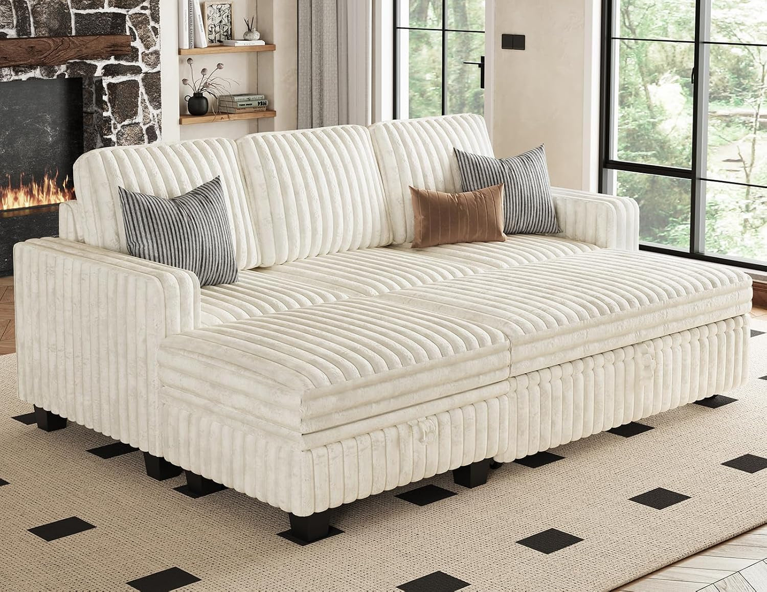 Low front-angle view of a cream modular sectional arranged as a wide sofa with three back cushions and accent pillows.