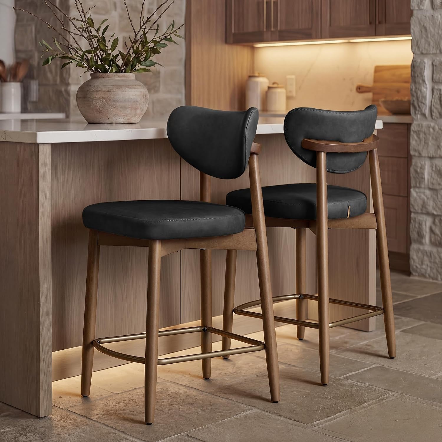 Two dark gray bar stools at a stone-floored kitchen island, side and back views