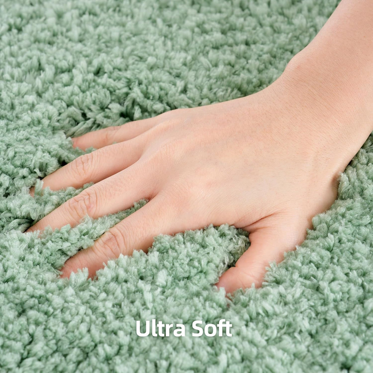 Hand pressing into dense, shaggy leaf-green microfiber pile to show softness