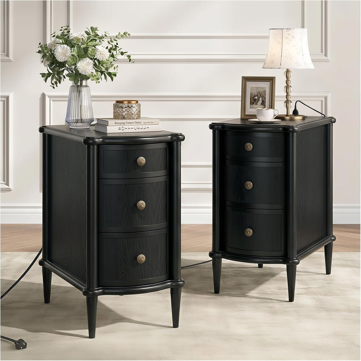 Pair of black round-front nightstands with fluted corners and three visible drawers each