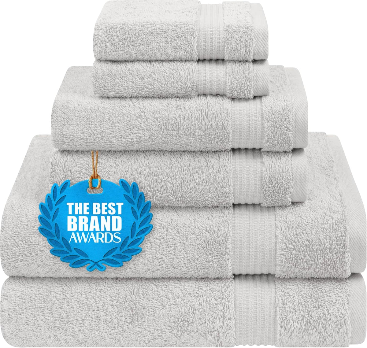 Neatly stacked light gray folded towels with a blue award tag on the front