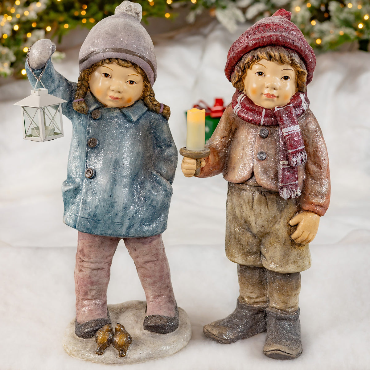 Boy and girl Christmas figurines with lantern and candle holder