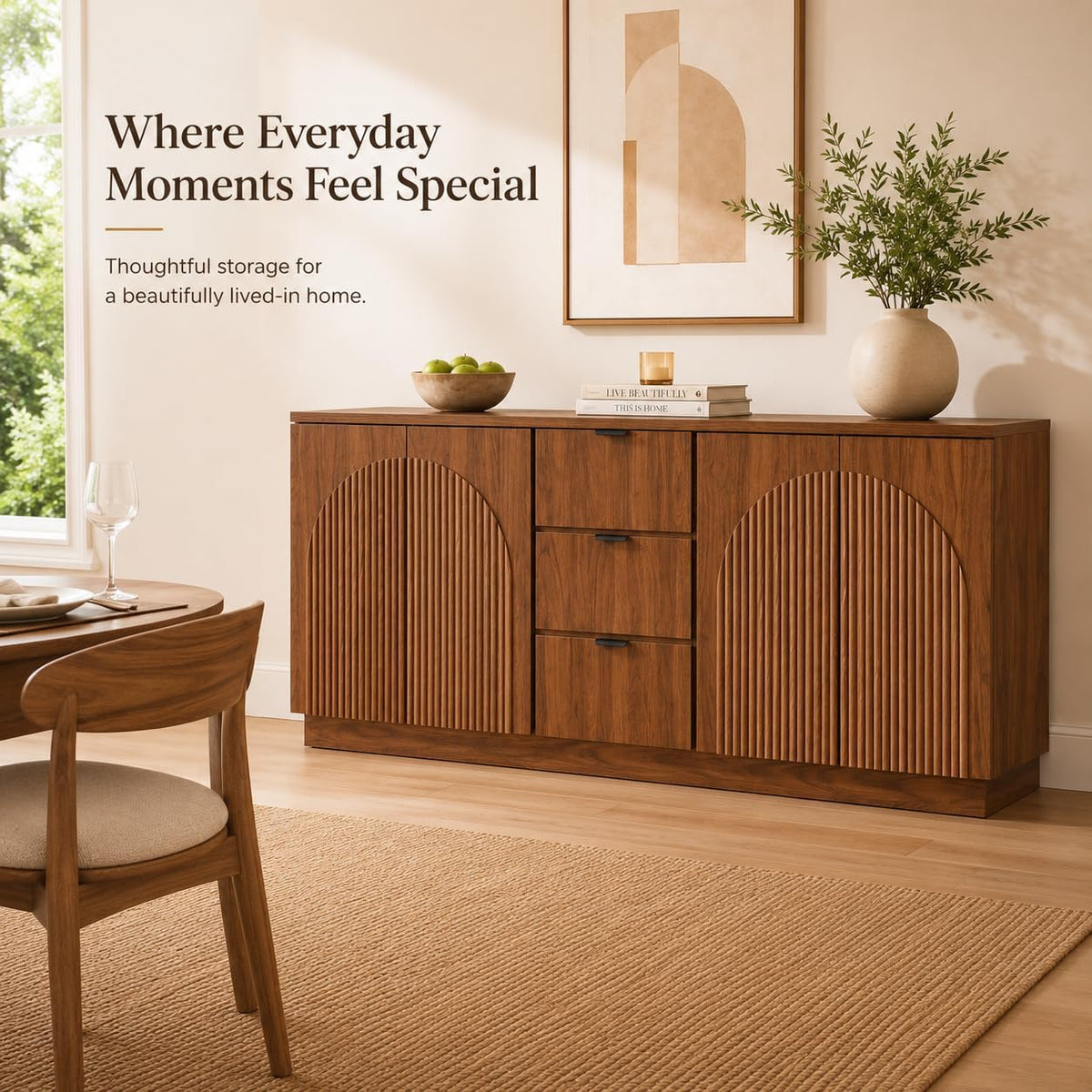 Walnut sideboard styled in dining area with artwork and vase on top, angled view.