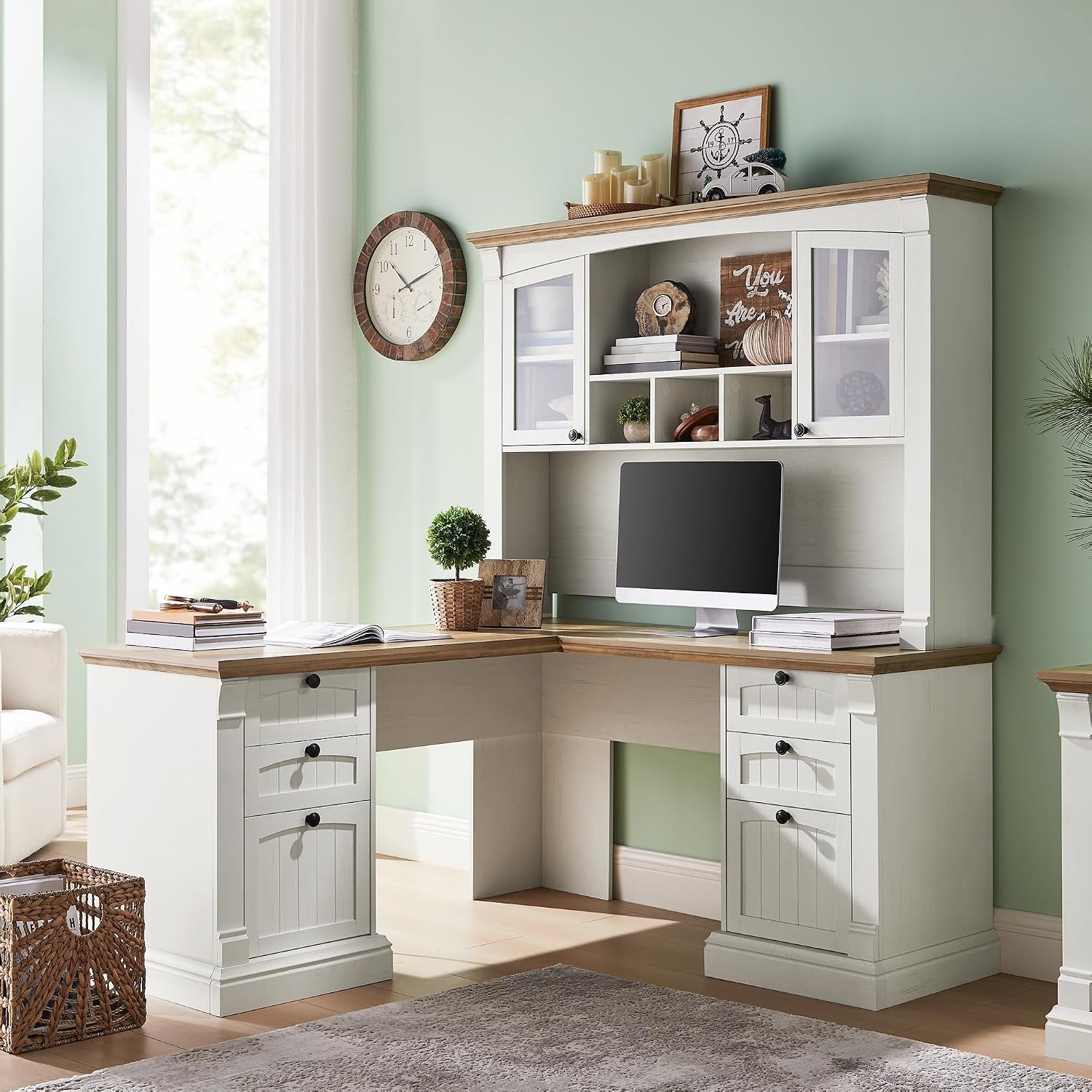 Antique white L-shaped desk with wood-tone top and 42 in hutch in a bright room, straight-on view with monitor on desk