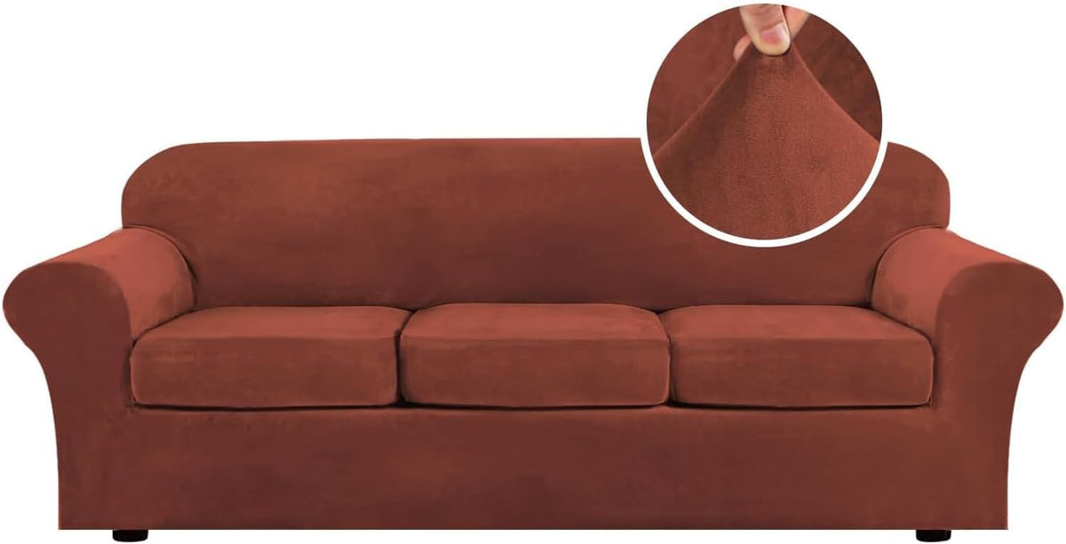 Front view of a rust-colored three-seat sofa with rounded arms and a circular inset of a hand pinching the plush fabric