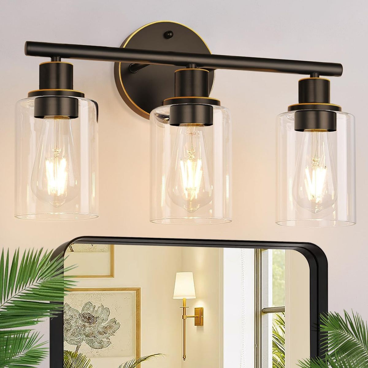Three-light black vanity light with clear glass shades and subtle gold trim accents.
