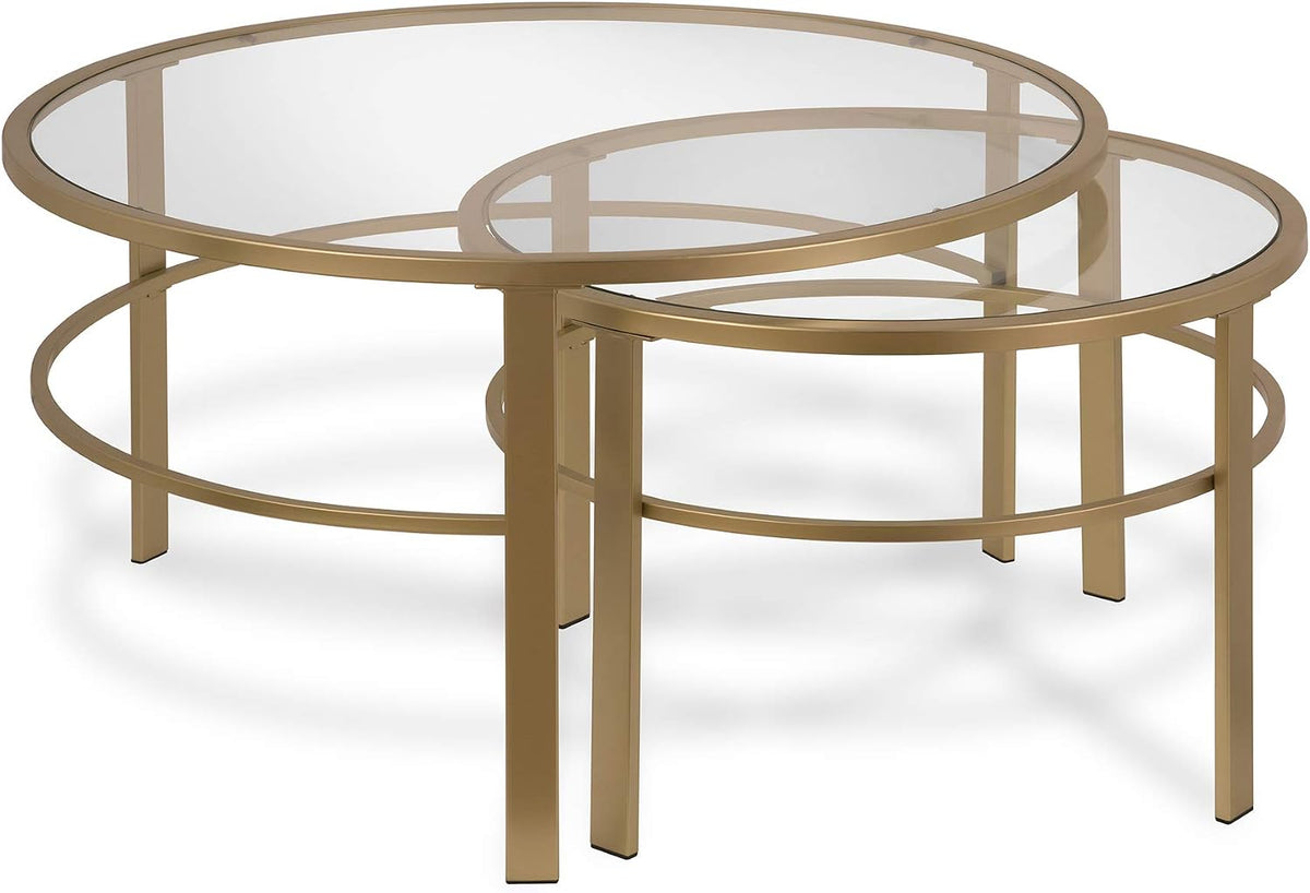 Two nesting round tables with clear glass tops and warm metallic frames positioned overlapping on white floor.