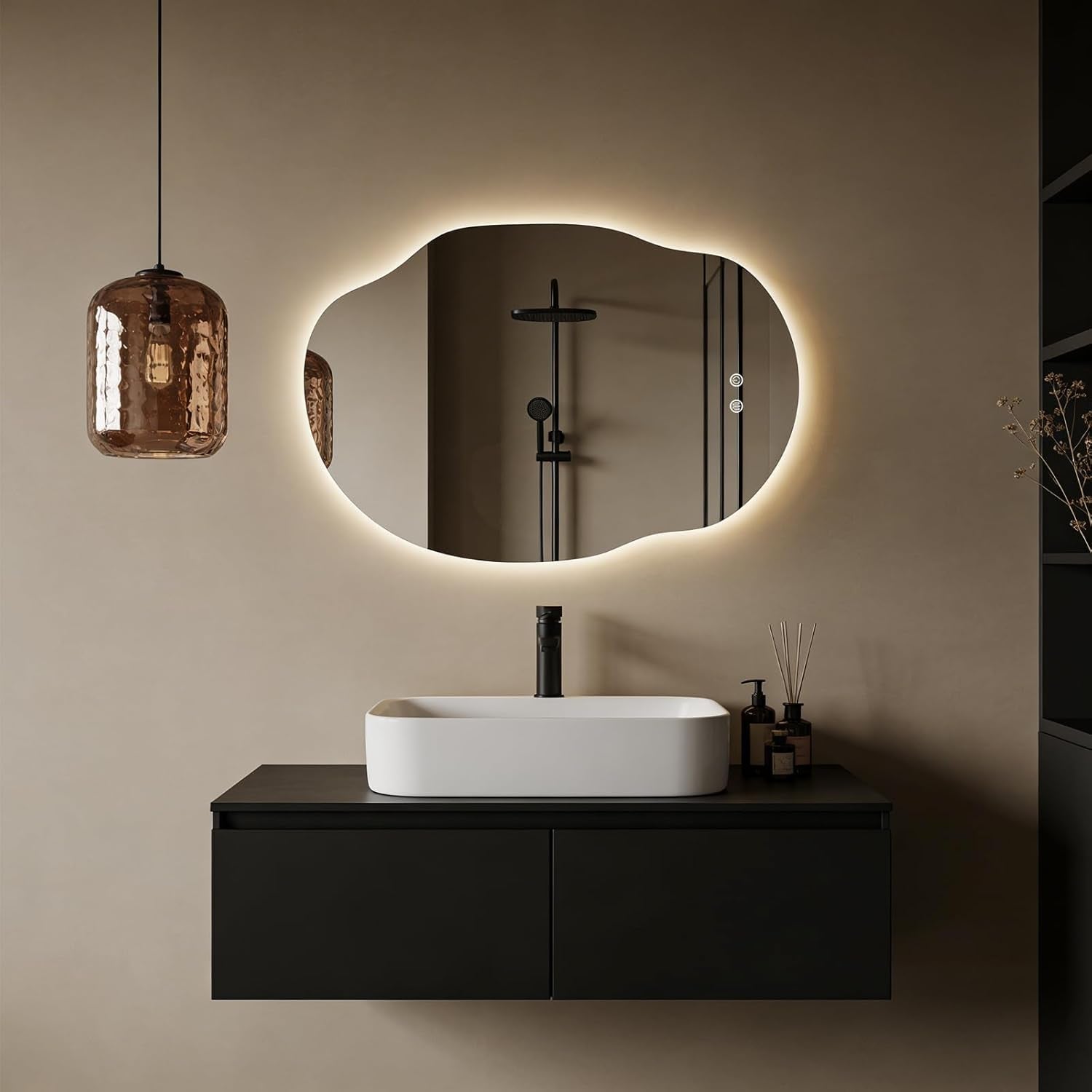 Horizontal organic-shaped LED mirror above dark floating vanity with a glass pendant light visible to the left