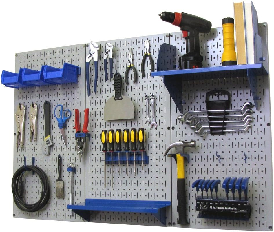 Light gray pegboard on wall with blue shelves and hooks holding pliers, screwdrivers, a drill and a hammer.