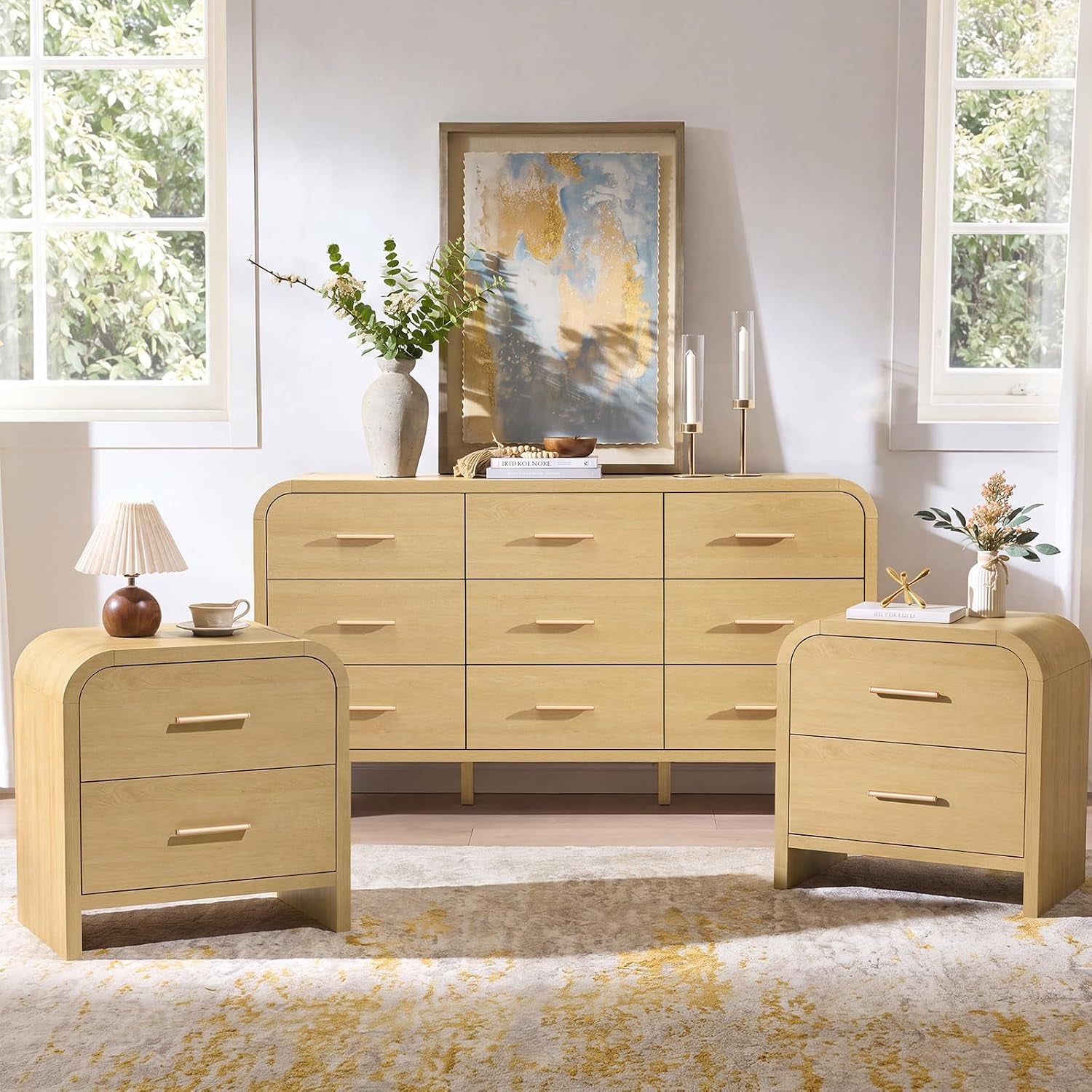 Styled room scene with the six-drawer dresser centered and two matching nightstands flanking it under windows.