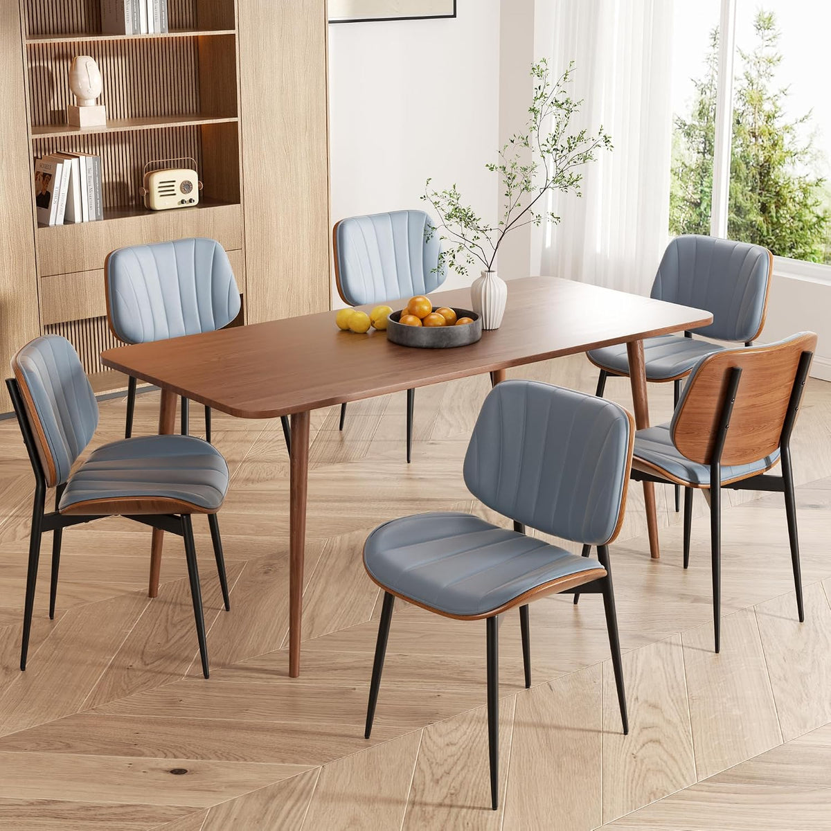 Angled view of the dining set highlighting blue faux leather chairs with walnut backs and black legs