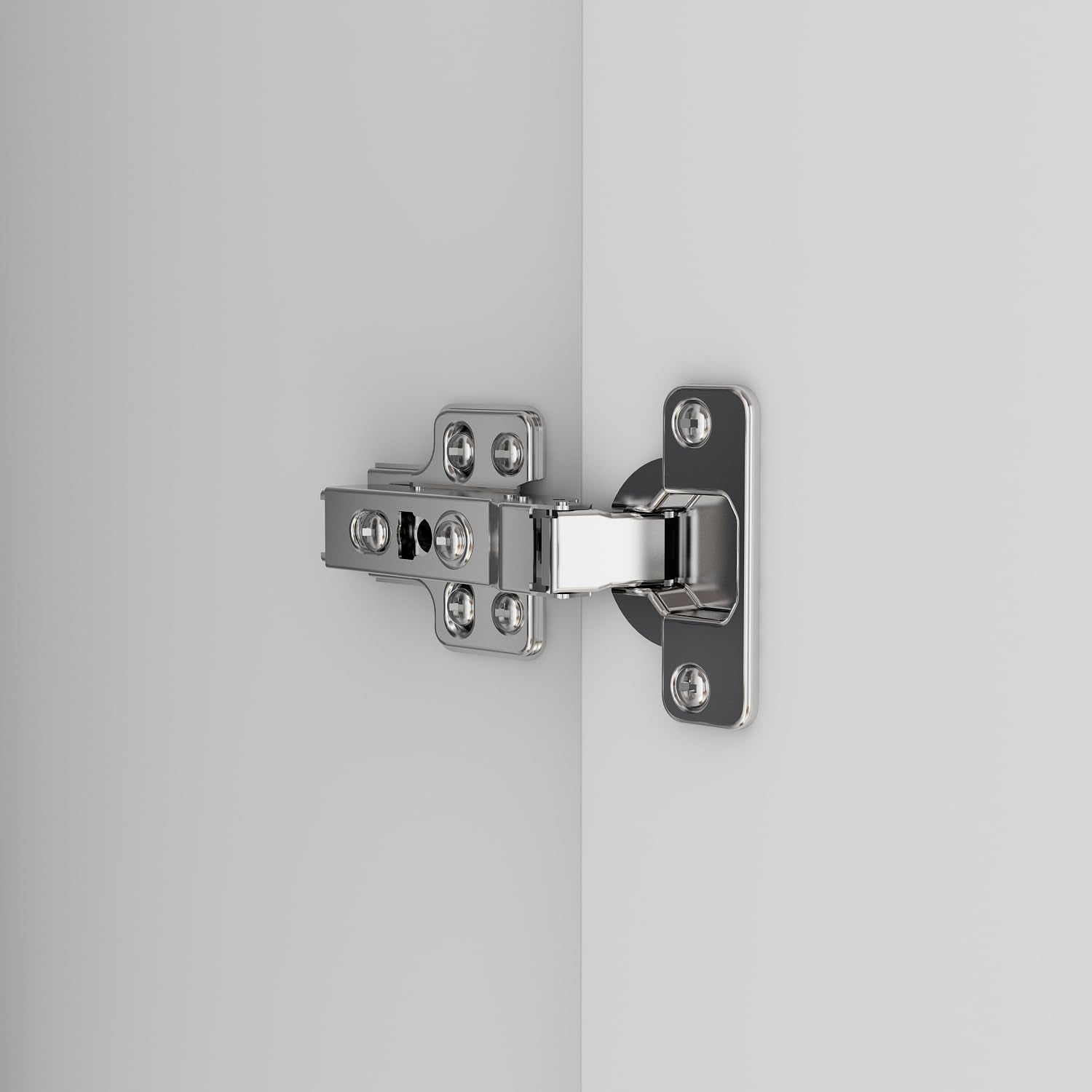 Close-up of a shiny metal cabinet hinge mounted on a white wardrobe door and frame.