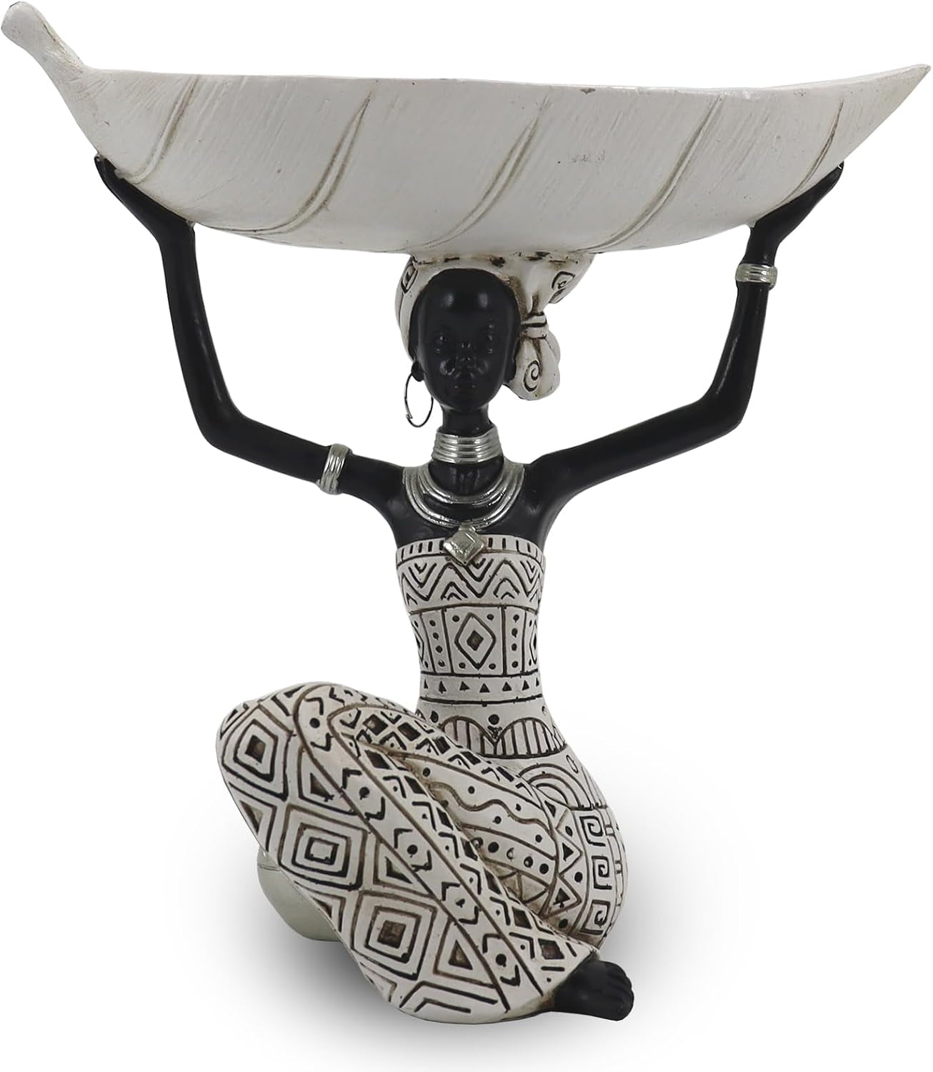 Kneeling black resin woman with patterned white clothing balancing a long shallow white bowl on her head