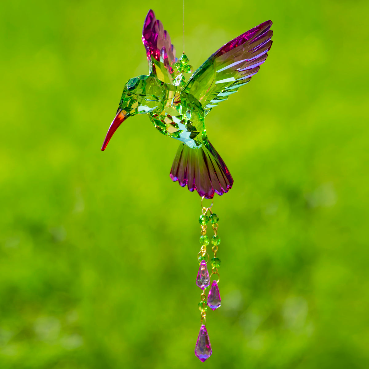 Green and magenta faceted hummingbird ornament with dangling beads, viewed from the opposite side.