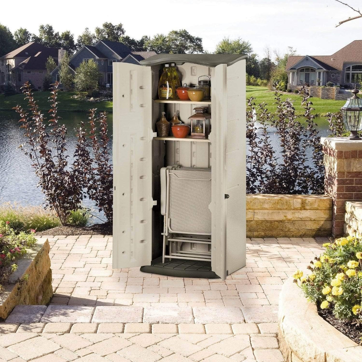 Open shed storing a folded chair on the floor with shelves above, shown on a patio setting