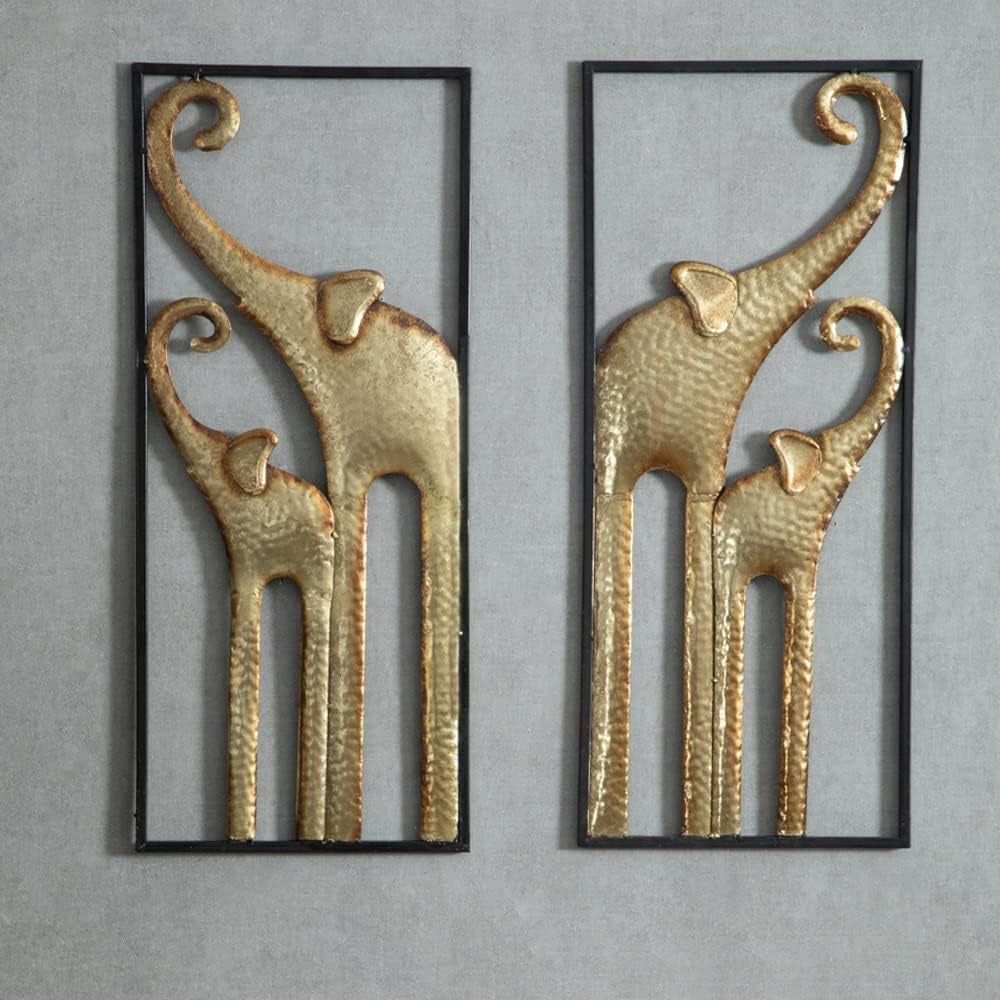 Pair of tall black-framed wall hangings featuring hammered gold elephant silhouettes mounted on a grey textured wall.