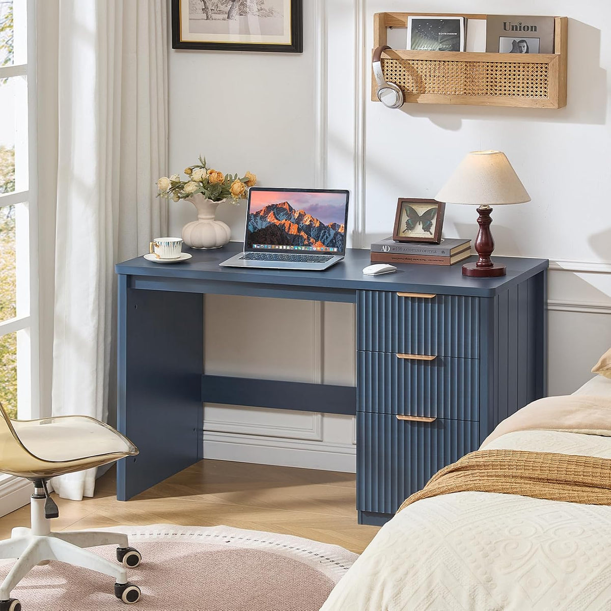Navy blue fluted desk styled in a bedroom scene with laptop and lamp showing overall desk in use