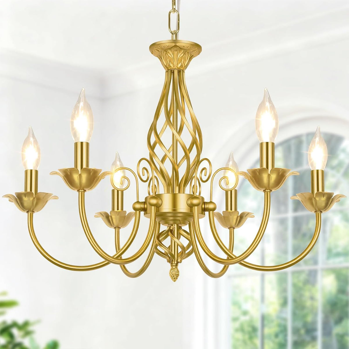 Close-up of the same six-arm chandelier in a polished gold finish against a bright background