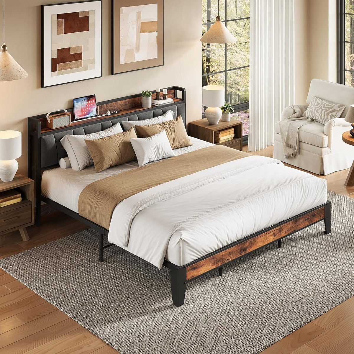 Fully made bed in a sunlit bedroom with pillows, bedside tables, a rug, and an upholstered headboard with wood trim.