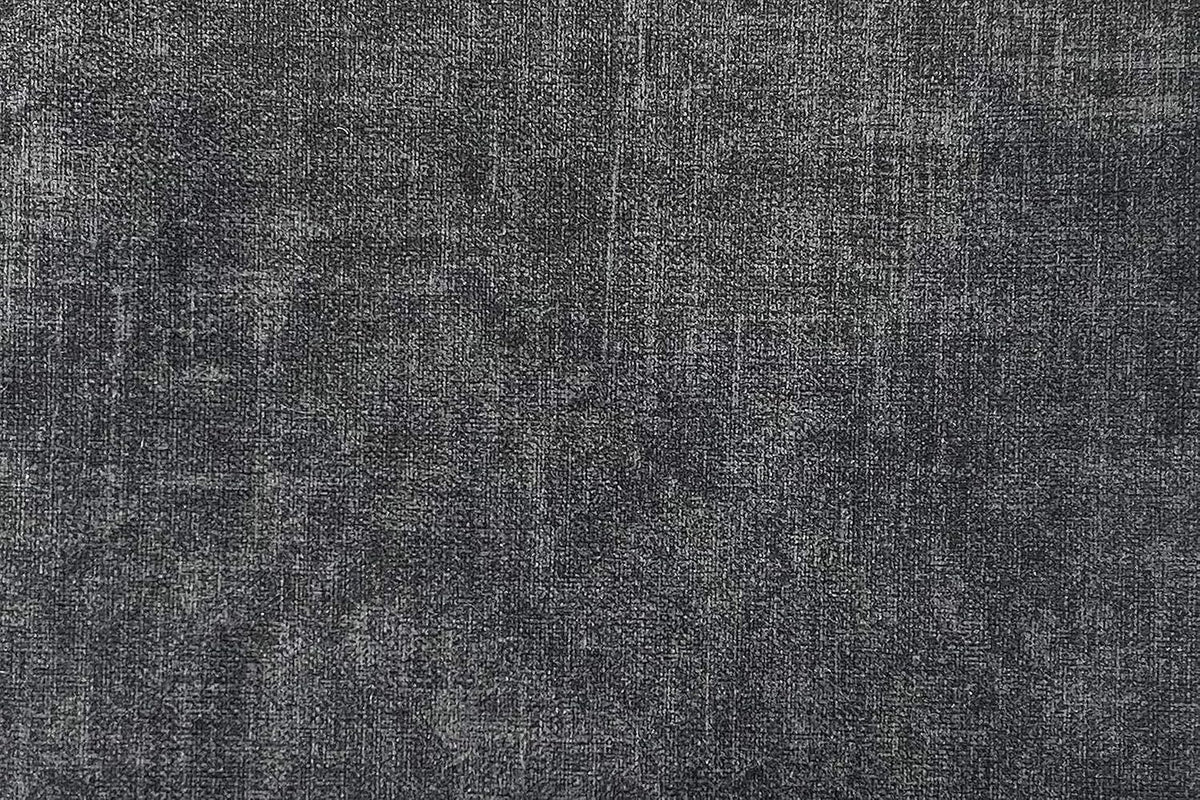 Close-up of deep grey velvet upholstery showing fabric texture and weave detail