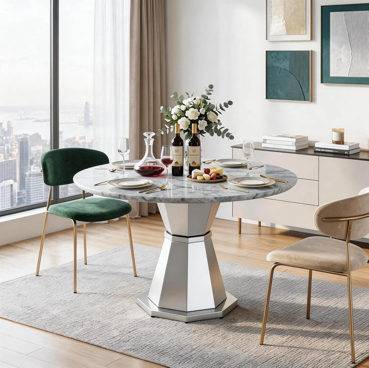 Round faux-marble dining table with a silver geometric pedestal, set with wine, plates and a white rose centerpiece, green