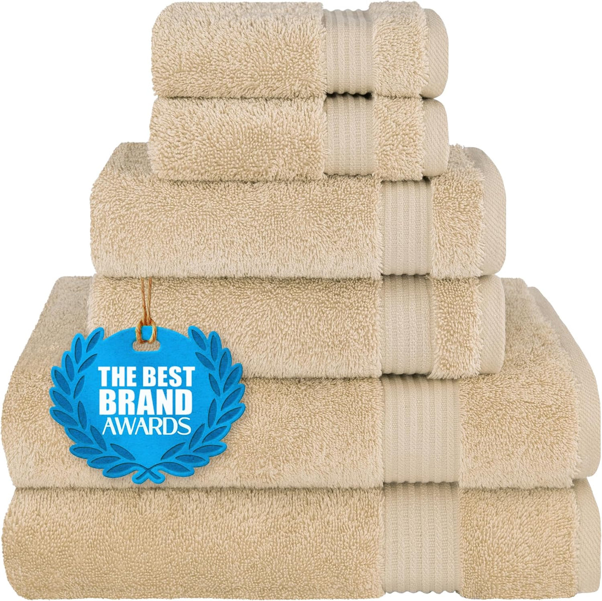 Stack of four rolled and folded beige towels with a blue award tag resting on the lower towel