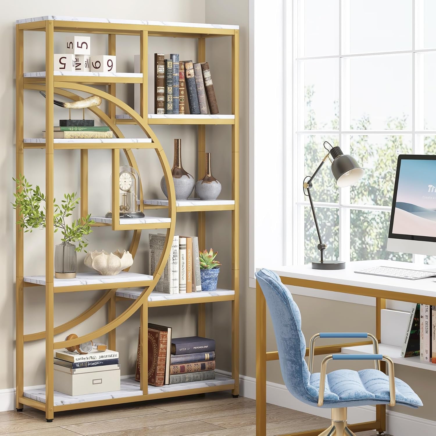 Gold etagere beside a desk showing half-moon frame and stacked decorative items in an office corner