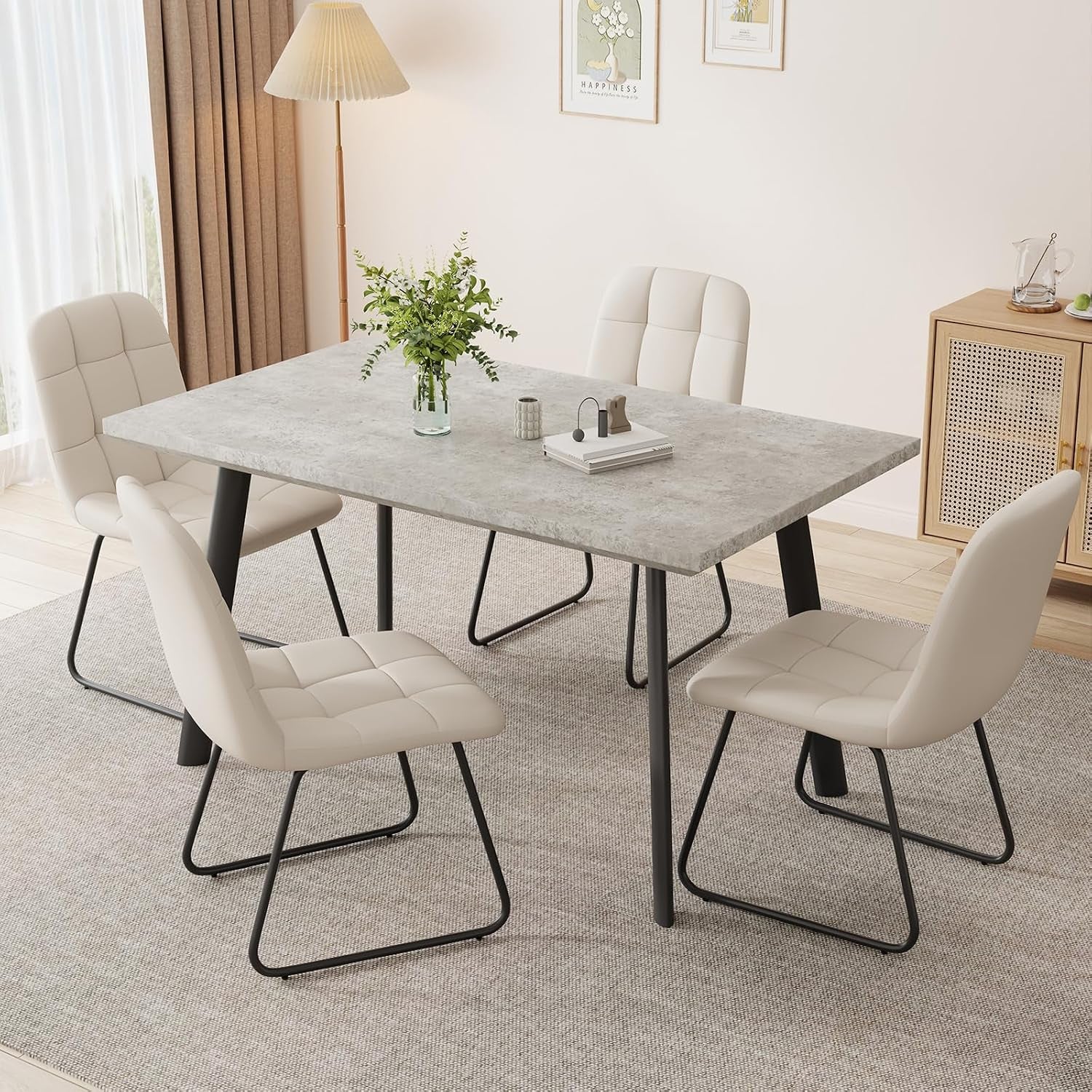 Gray concrete-look tabletop paired with cream tufted sled-base chairs on a textured rug.