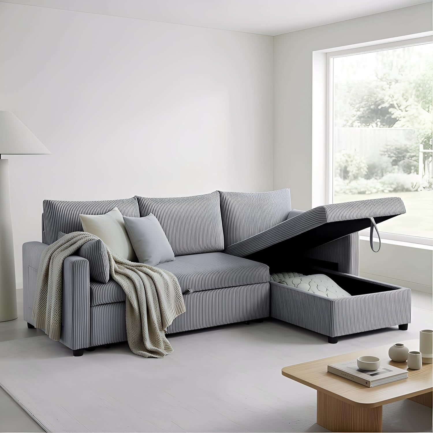 Striped gray chaise lifted to reveal a storage compartment, throw blanket draped over arm.