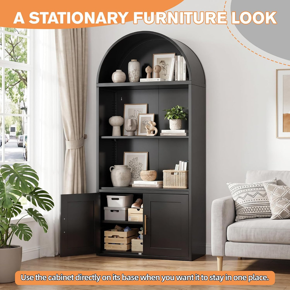 Black arched metal bookshelf styled in a living room with open display shelves and a lower double-door storage cabinet