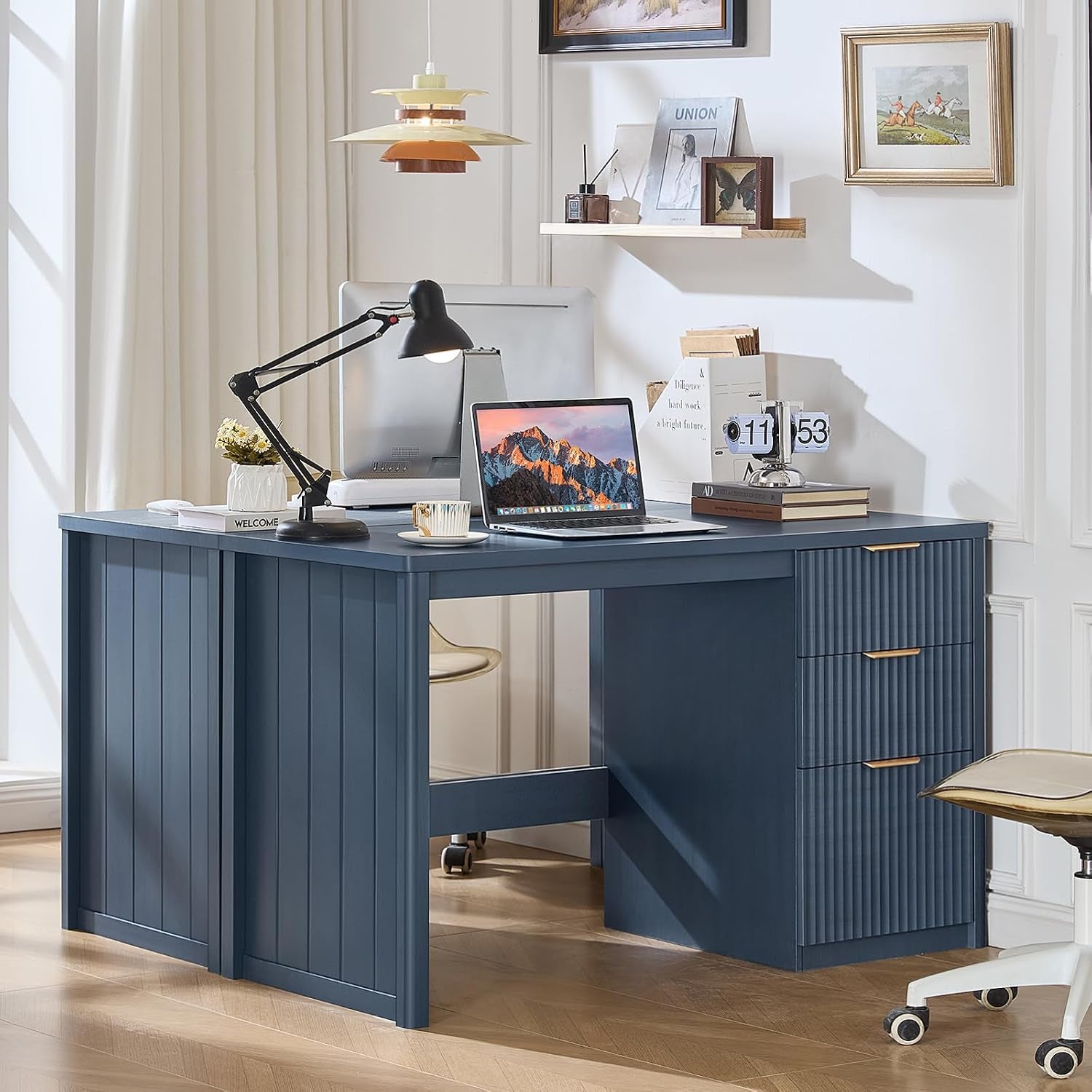 Blue fluted executive desk in a bright home office, styled with a laptop, desk lamp, and wall art.