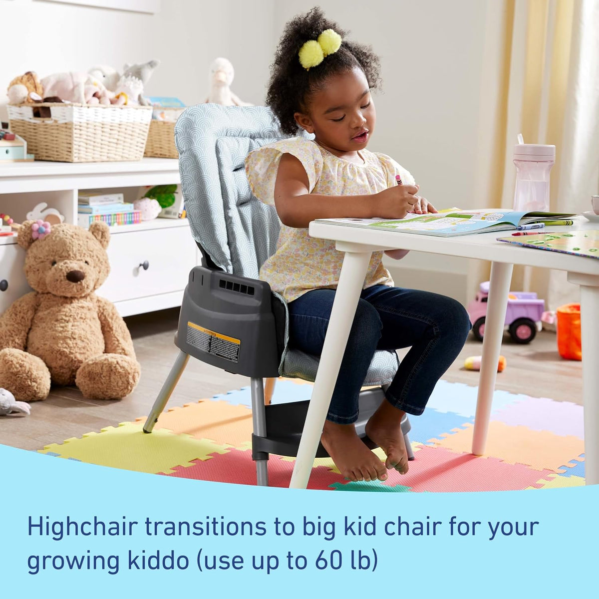 Older child seated at a table using the highchair converted to a kid chair in a playroom setting