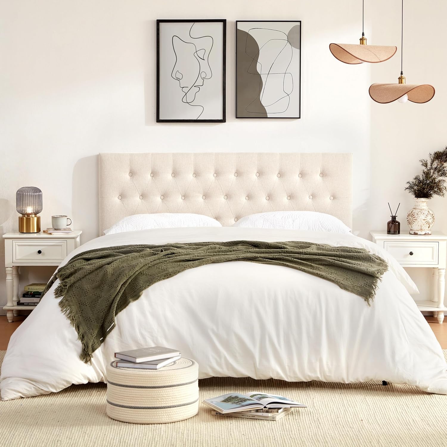Beige tufted headboard front view styled in a bedroom with white bedding and framed artwork above