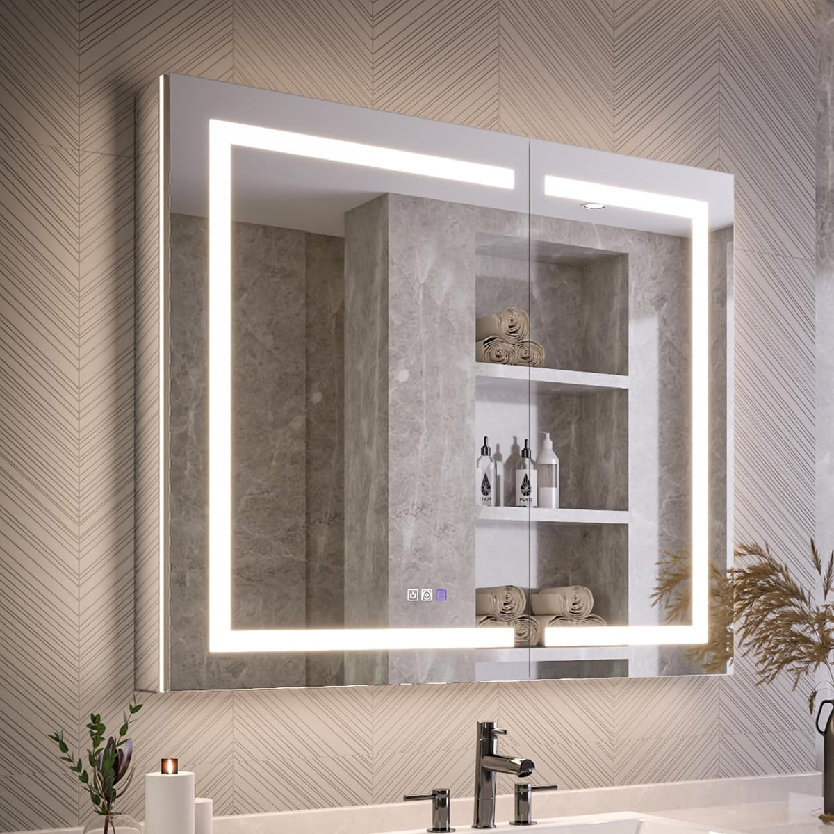 Close front view of mirror showing bright LED frame and small touch-control icons at the lower center, faucet reflected