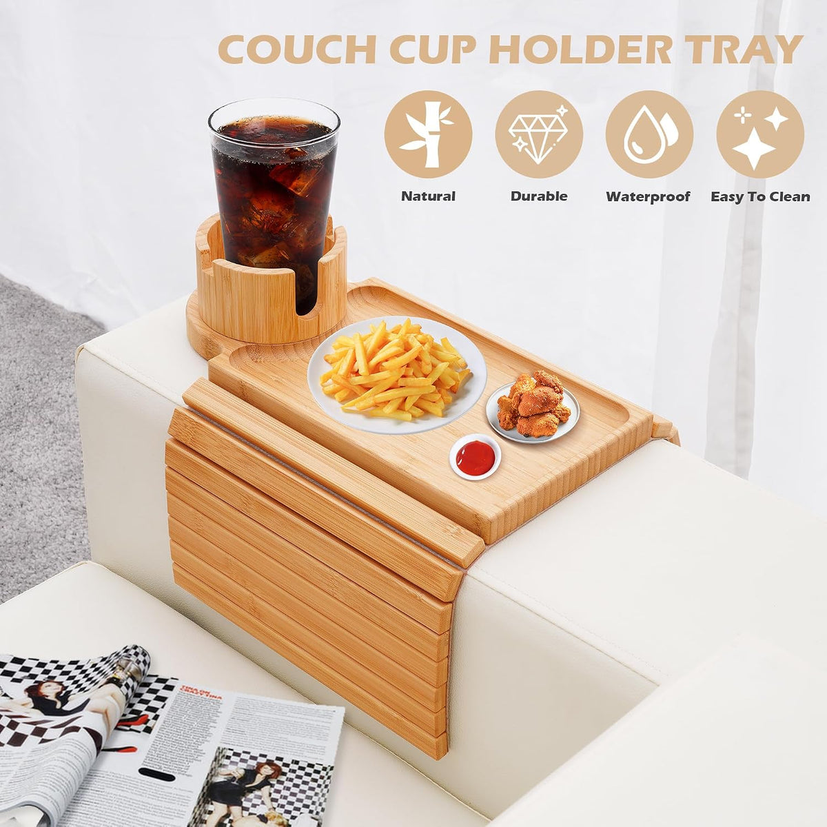 Lifestyle shot of the bamboo cup holder tray on a white sofa arm with a drink, plate of fries and snacks