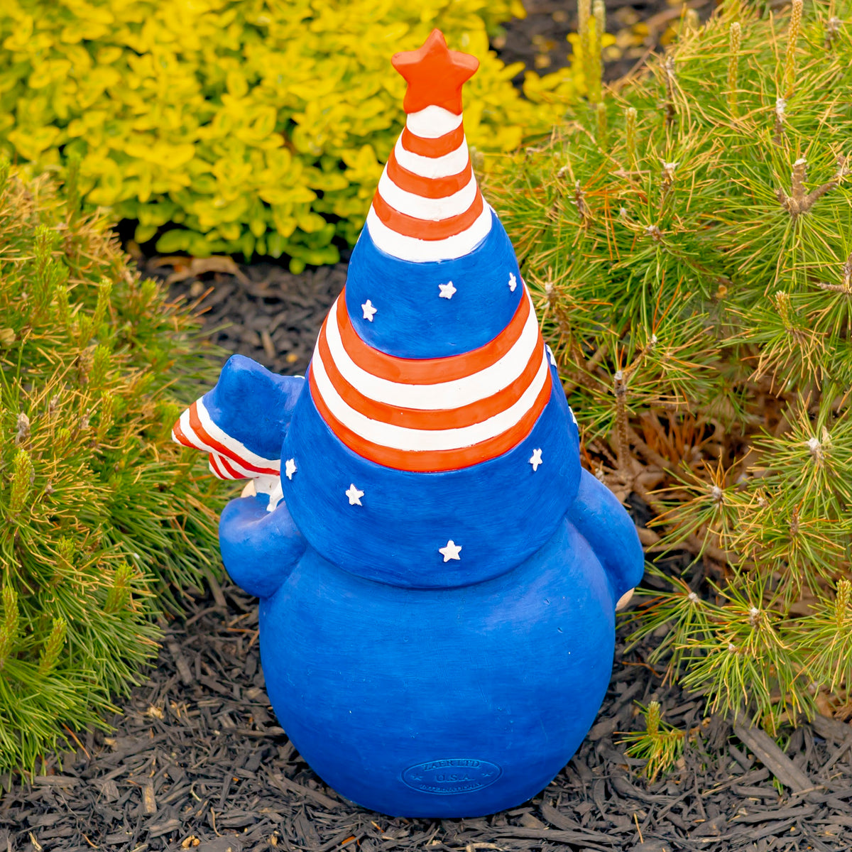Back of the gnome, showing its blue body and red-and-white striped, star-decorated hat.
