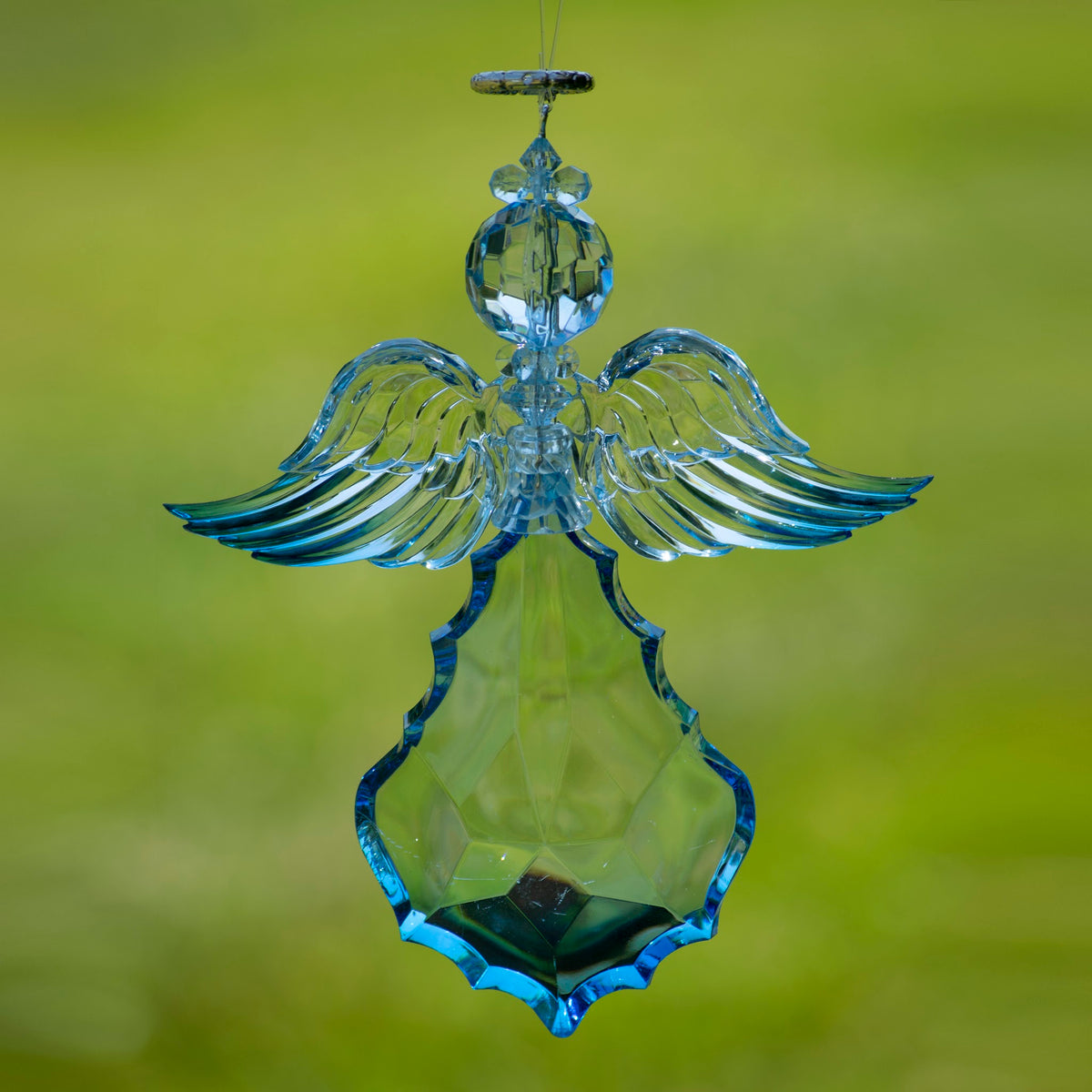 Hanging blue angel ornament with wide, horizontally spread wings and a faceted body.