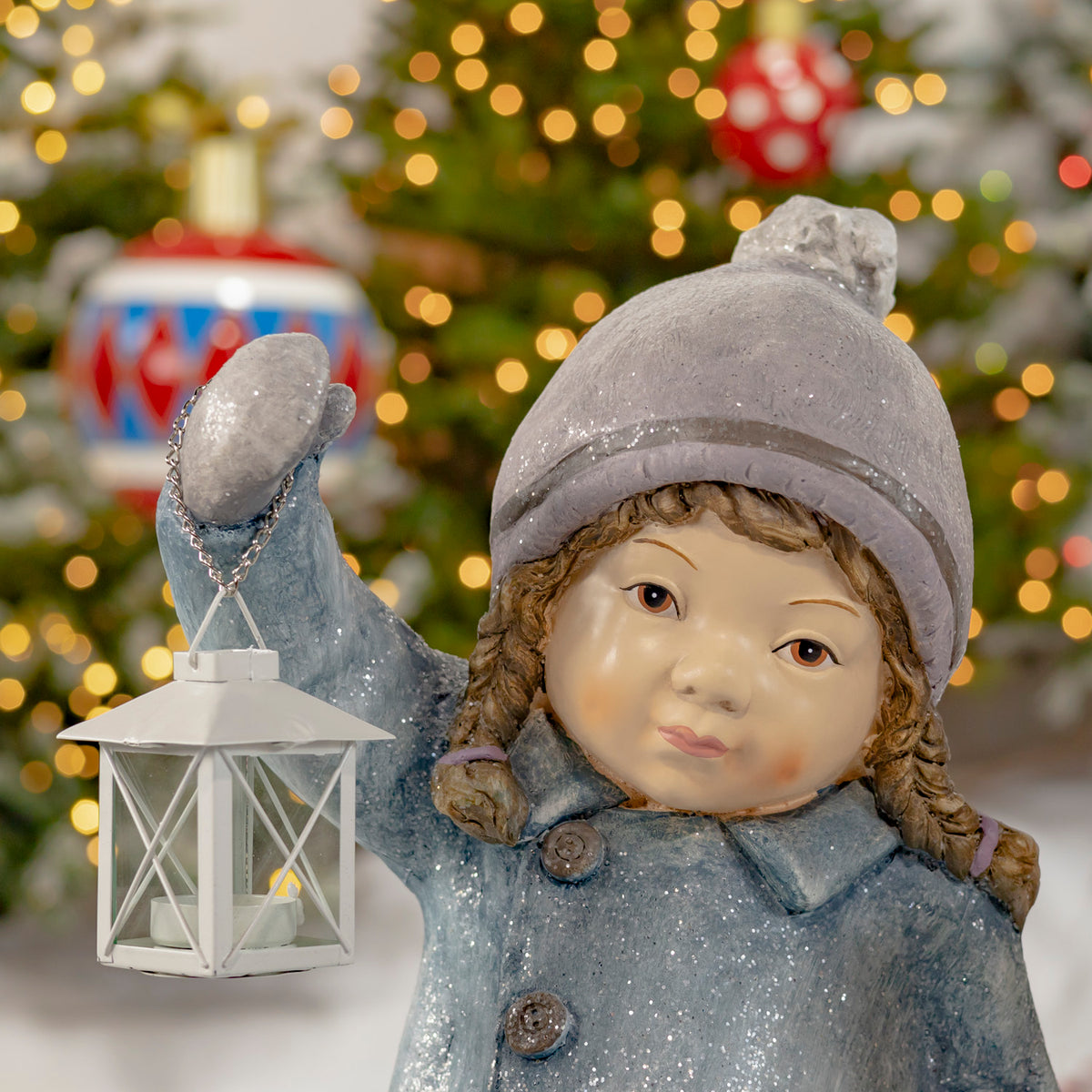 Close-up of the blue-clad Christmas figure holding a hanging lantern