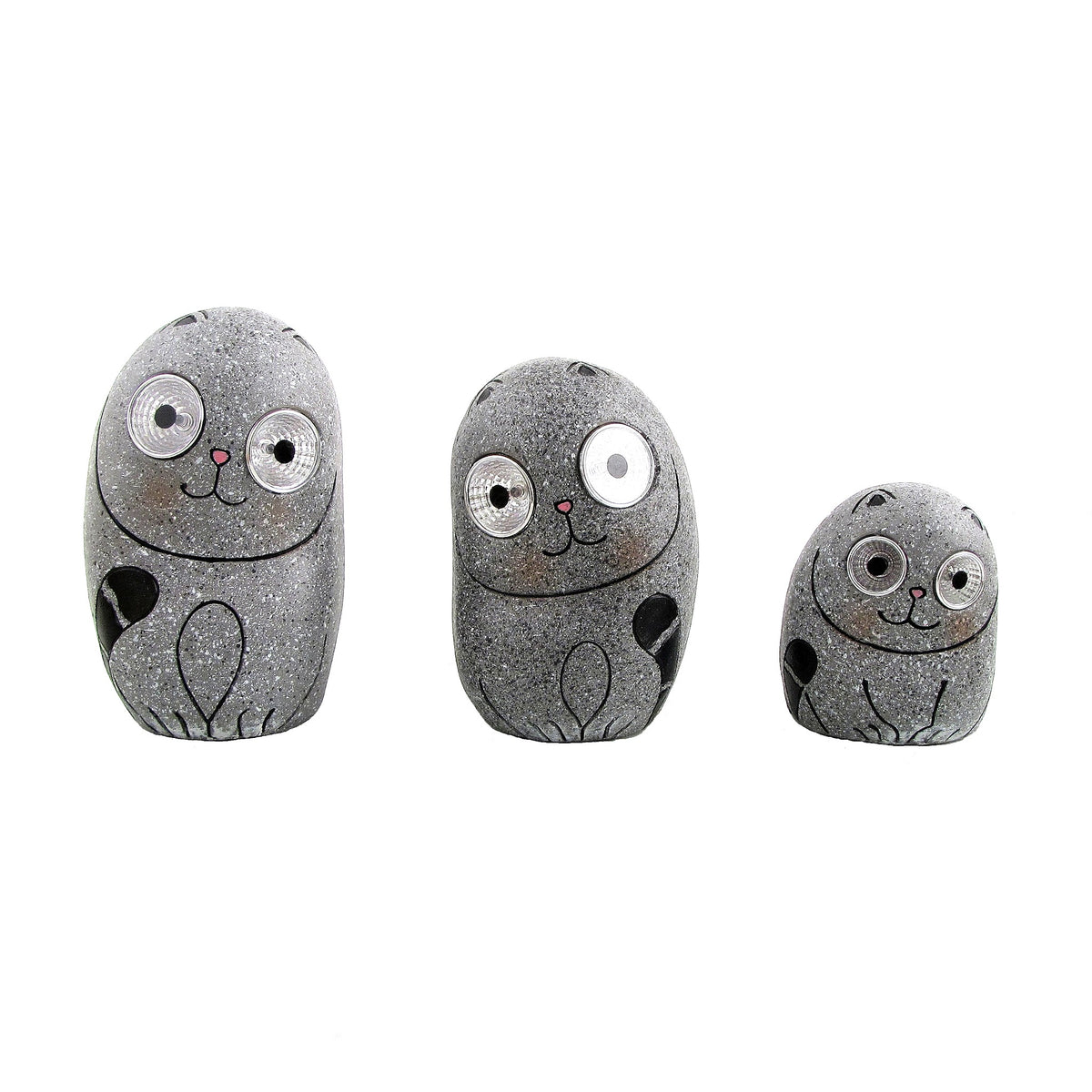 Three speckled gray cat ornaments stand separately against a white background, with one smaller than the others.