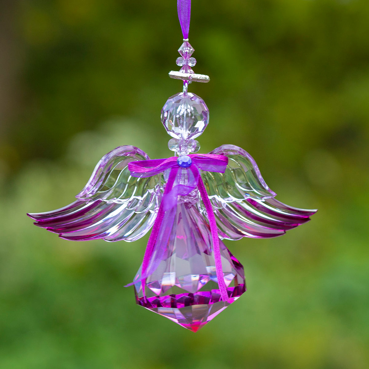 Purple angel ornament with outstretched layered wings, a ribbon bow, and a pointed faceted skirt.