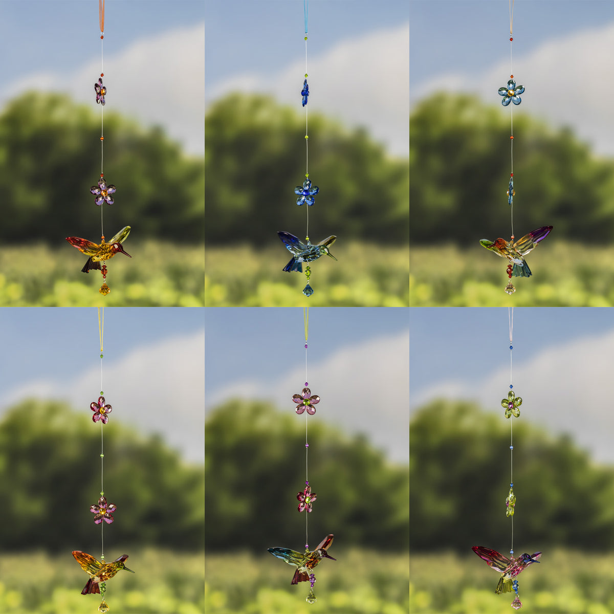 Three vertical strands of faceted hummingbird and flower ornaments against a blurred garden.
