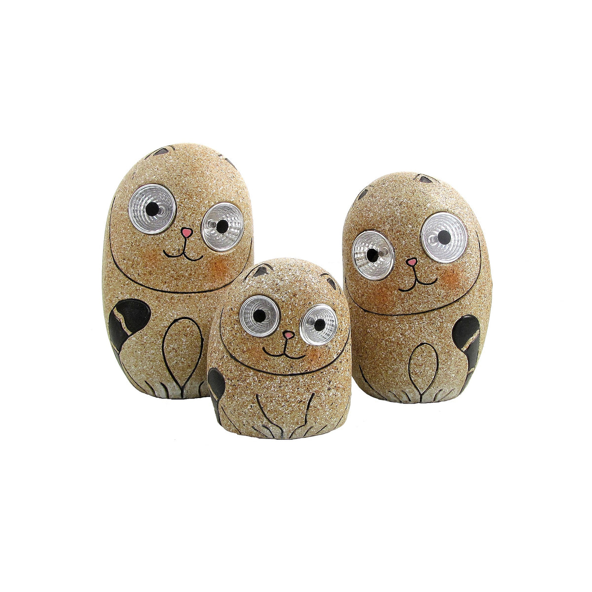 Three glittery taupe cat figures arranged together, with painted paws, curled tails and oversized eyes.