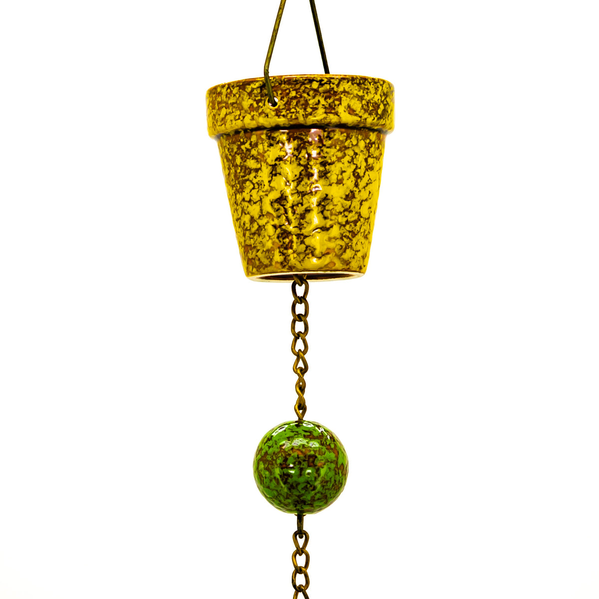 Close-up of a yellow mottled bucket and a green patterned bead linked by bronze-colored chain.